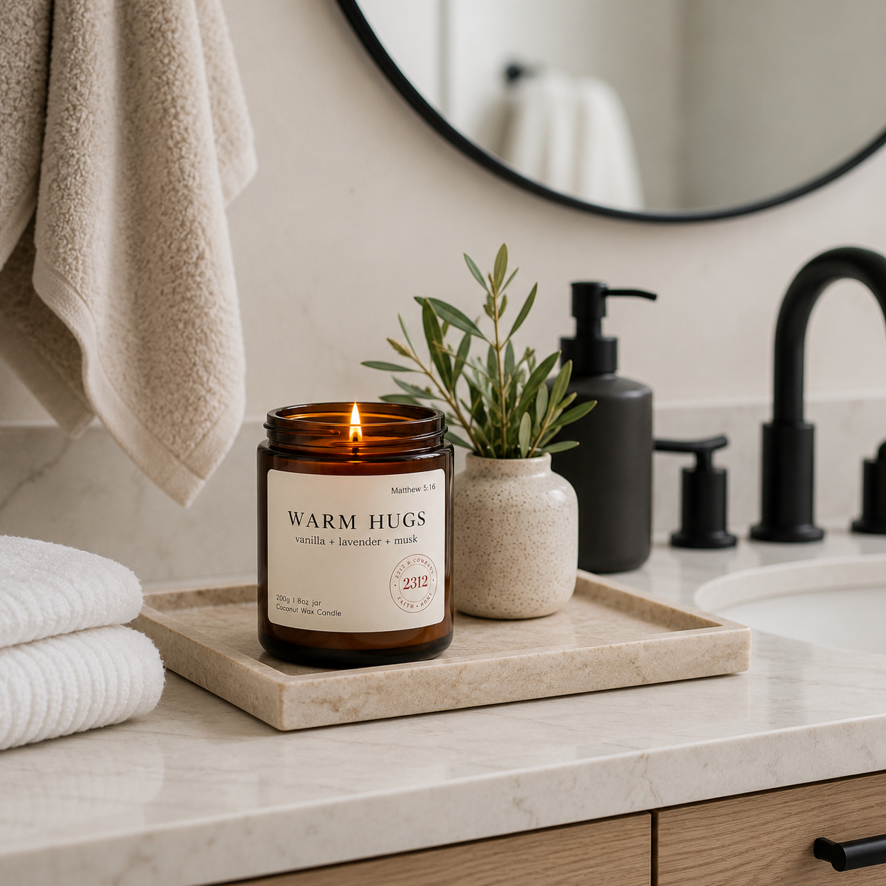Warm Hugs coconut wax candle on a bathroom counter in a modern spa bathroom.