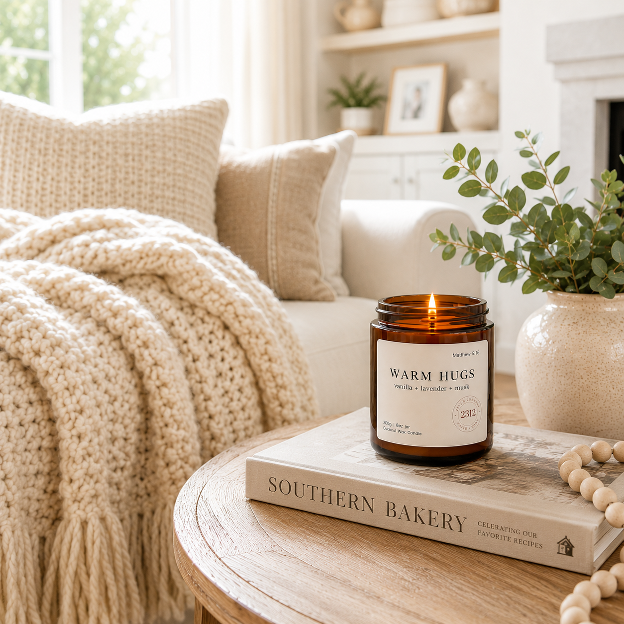 Warm Hugs luxury coconut wax candle in a bright cozy living room with warm neutral décor.